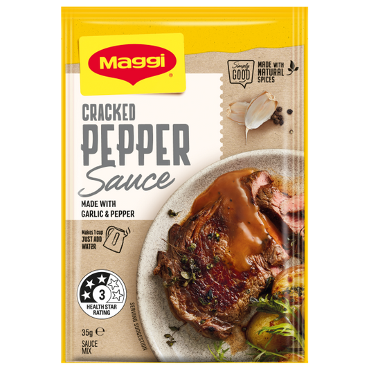 Maggi Cracked Pepper Sauce packet with a steak dish on a white background