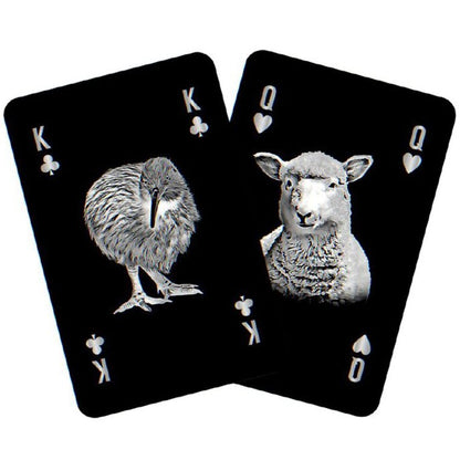 Two playing cards featuring a kiwi bird and a sheep on a white background